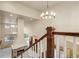 Open-concept foyer with stone fireplace, hardwood floors, and modern lighting at 2344 S Lupine St, Denver, CO 80228