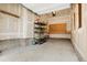 Functional garage with storage shelves; perfect for organizing tools and gardening supplies at 2344 S Lupine St, Denver, CO 80228