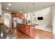 Gourmet kitchen with stainless steel appliances, a center island, and an open floor plan at 2344 S Lupine St, Denver, CO 80228