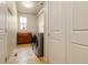 Well-equipped laundry room with washer, dryer, sink, and ample cabinet space at 2344 S Lupine St, Denver, CO 80228