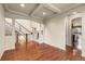 Bright and open living room showcasing hardwood floors, staircase, and an open doorway at 2344 S Lupine St, Denver, CO 80228