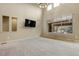 Spacious living room with a large window, high ceilings, and neutral carpet at 2344 S Lupine St, Denver, CO 80228