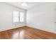 Cozy bedroom with hardwood floors, large window, and ample natural light at 1420 Osceola St, Denver, CO 80204