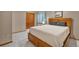 Inviting bedroom featuring a comfortable queen bed, closet, and soft natural light from an adjacent window at 7340 Brixham Cir, Castle Pines, CO 80108