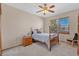This is a cozy bedroom featuring a classic wooden bed frame and a ceiling fan with light fixture at 7340 Brixham Cir, Castle Pines, CO 80108