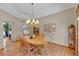 Formal dining room with chandelier lighting, hardwood floors, and space for entertaining at 7340 Brixham Cir, Castle Pines, CO 80108