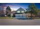 Charming two-story home features a 3-car garage, lush lawn, and well-maintained landscaping under a beautiful evening sky at 7340 Brixham Cir, Castle Pines, CO 80108