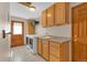 Bright laundry room with wood cabinets, sink, and washer/dryer near exterior door for easy access at 7340 Brixham Cir, Castle Pines, CO 80108