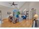 Bright living room with high ceilings, fireplace, hardwood floors, and ample seating at 7340 Brixham Cir, Castle Pines, CO 80108