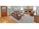 Spacious living room with a brick fireplace, large windows, and comfortable seating at 7340 Brixham Cir, Castle Pines, CO 80108
