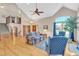 Spacious living room with vaulted ceilings, hardwood floors, and a large window for plenty of natural light at 7340 Brixham Cir, Castle Pines, CO 80108