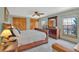 Main bedroom with a sleigh bed, wood dresser, windows, and ceiling fan for a comfortable ambiance at 7340 Brixham Cir, Castle Pines, CO 80108
