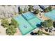 Aerial view of community tennis, basketball, and pickleball courts near playground and green space at 7340 Brixham Cir, Castle Pines, CO 80108