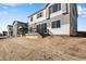 A newly constructed backyard with sown grass, patio, and home exterior at 10022 Wheeling St, Commerce City, CO 80022