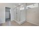 Modern bathroom featuring a tiled walk-in shower with glass doors and neutral tile at 10022 Wheeling St, Commerce City, CO 80022