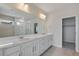 Primary bathroom with double vanity, large mirror, and glass-enclosed shower for a luxurious feel at 10022 Wheeling St, Commerce City, CO 80022