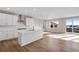 Spacious kitchen with a central island, white cabinets, and access to a balcony at 10022 Wheeling St, Commerce City, CO 80022