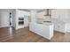 Bright kitchen featuring white cabinetry, a central island, and modern stainless steel appliances at 10022 Wheeling St, Commerce City, CO 80022