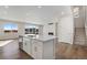 Bright, modern kitchen with an island and fireplace near stairs at 10022 Wheeling St, Commerce City, CO 80022