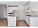 Bright kitchen with a central island, white cabinets, and modern stainless steel appliances at 10022 Wheeling St, Commerce City, CO 80022