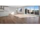 Open living space with hardwood floors, natural light, and partial kitchen view at 10022 Wheeling St, Commerce City, CO 80022