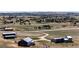 Aerial view of a neighborhood with vast landscapes, multiple buildings, and mountain views at 43010 Ptarmigan Ranch St, Parker, CO 80138
