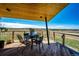 Enjoy outdoor dining on this covered porch, offering scenic views of the surrounding landscape at 43010 Ptarmigan Ranch St, Parker, CO 80138