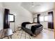 Bright bedroom featuring hardwood floors, ceiling fan, and two windows at 43010 Ptarmigan Ranch St, Parker, CO 80138