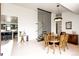 Bright dining room with a modern chandelier, sleek staircase, and views into the kitchen at 43010 Ptarmigan Ranch St, Parker, CO 80138