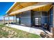 Inviting covered entry with stone accents, wooden ceiling and door, and comfortable seating area at 43010 Ptarmigan Ranch St, Parker, CO 80138