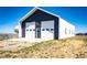 Spacious garage with multiple doors and additional storage for vehicles and equipment at 43010 Ptarmigan Ranch St, Parker, CO 80138