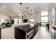 Open-concept kitchen boasts a large island, modern appliances, and scenic views at 43010 Ptarmigan Ranch St, Parker, CO 80138