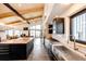 Bright kitchen boasting an island and stainless steel sink, windows offer a view to the exterior at 43010 Ptarmigan Ranch St, Parker, CO 80138