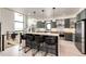 Elegant kitchen with breakfast bar, modern lighting, and stainless steel appliances at 43010 Ptarmigan Ranch St, Parker, CO 80138