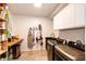 Well-equipped laundry room with modern washer and dryer, ample storage, and tiled floors at 43010 Ptarmigan Ranch St, Parker, CO 80138