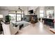 Bright living room with a modern fireplace, hardwood floors, and large windows overlooking a view at 43010 Ptarmigan Ranch St, Parker, CO 80138