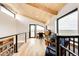 Upper loft office space with views to the exterior, hardwood floors and railing at 43010 Ptarmigan Ranch St, Parker, CO 80138