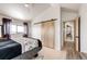 Bright bedroom featuring a sliding wood door, a large window, and sleek, modern finishes at 43010 Ptarmigan Ranch St, Parker, CO 80138