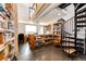 Spacious home office featuring built-in bookshelves, and spiral staircase to an upper loft at 43010 Ptarmigan Ranch St, Parker, CO 80138