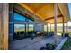 Covered patio area with sliding glass doors, ample seating, and serene outdoor views at 43010 Ptarmigan Ranch St, Parker, CO 80138