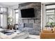 Chic living room featuring a stone fireplace, modern decor, and comfortable furnishings at 4349 N Meadows Dr, Castle Rock, CO 80109