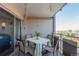 Outdoor balcony area with a small dining table, chairs, and outdoor foliage at 800 N Washington St # 804, Denver, CO 80203