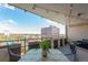 Outdoor balcony area that is strung with lights, has a table and chairs and offers wonderful city views at 800 N Washington St # 804, Denver, CO 80203