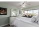 Bright bedroom featuring large windows with city views, white furniture, and a ceiling fan at 800 N Washington St # 804, Denver, CO 80203