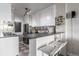 Modern kitchen with stainless steel appliances, white cabinets, and breakfast bar at 800 N Washington St # 804, Denver, CO 80203