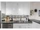 Bright kitchen features gray countertops, white cabinetry, and stainless steel dishwasher at 800 N Washington St # 804, Denver, CO 80203