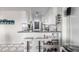 Charming kitchen with white cabinets, breakfast bar, updated appliances, track lighting, and stylish diamond pattern backsplash at 800 N Washington St # 804, Denver, CO 80203