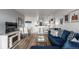 Cozy living room featuring hardwood floors, blue sofa, and dining area at 800 N Washington St # 804, Denver, CO 80203