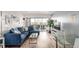 Bright living room with balcony access, blue sofa, and modern furnishings at 800 N Washington St # 804, Denver, CO 80203