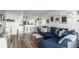 Open living room area with blue sofa, hardwood floors, and kitchen access at 800 N Washington St # 804, Denver, CO 80203